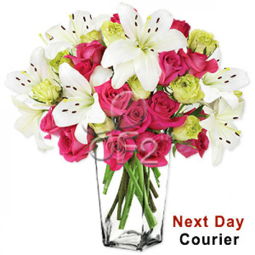 Bursting with style, color and extravagance, this luxurious arrangement featuring gorgeous pink and green or yellow roses surrounded by stems of white lilies arranged in a glass vase, will add charm and elegance to your loved ones day. #best