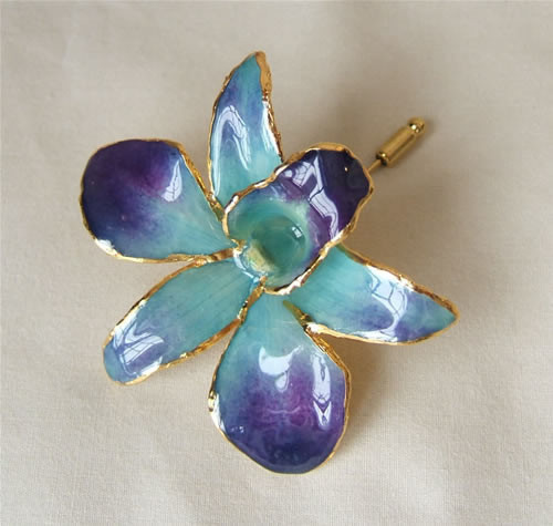 Picked at the peak of its natural perfection, a lush, exotic orchid blossom gives this Blue Dendrobium Orchid brooch its ethereal beauty. Each delicate, vibrant flower is skillfully preserved in lacquer and trimmed with touches of 24K gold. The Blue Orchi #gift
