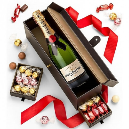 Set a romantic tone with gourmet chocolates and fine champagne. This Romantic Wine Basket says I love you with chocolates and wine. A designer two compartment gift box with a red ribbon bow arrives with gourmet chocolates and Moet and Imperial Bruit Champ #wine