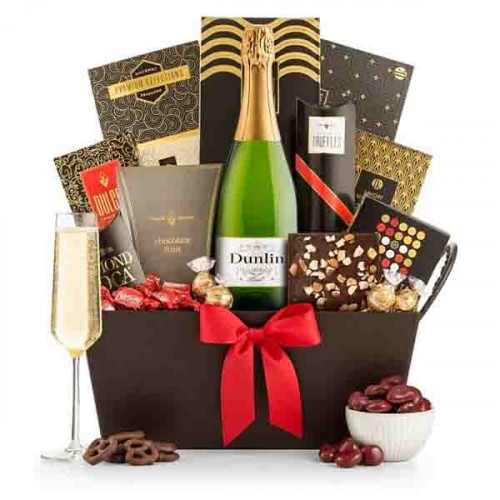Nothing compares to the gift of champagne for celebrating life's special occasions. To complement the Chandon White Star champagne, an elegant willow tray boasts a generous assortment of our finest gourmet & sweet treats. #luxury